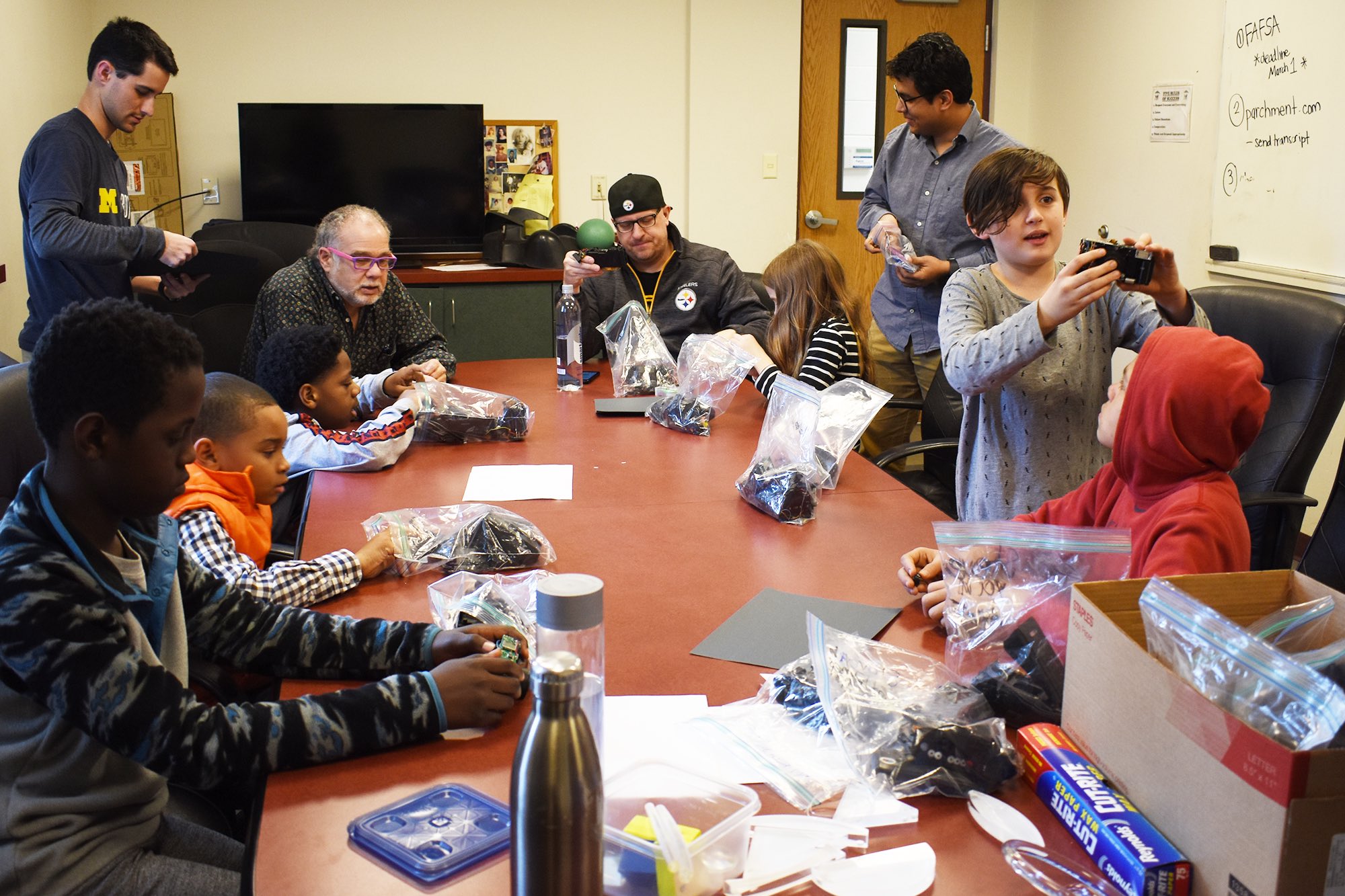 kids break out disassembled electronic pieces