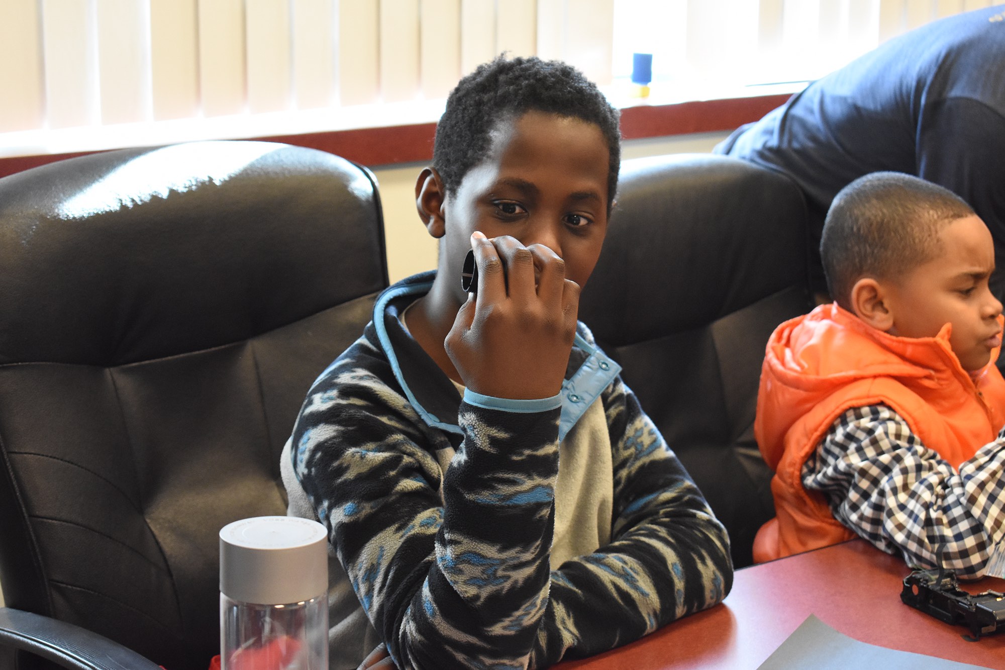Student examines disassembled electronic pieces